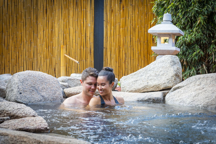 couple in outdoor mineral springs pool 700x467
