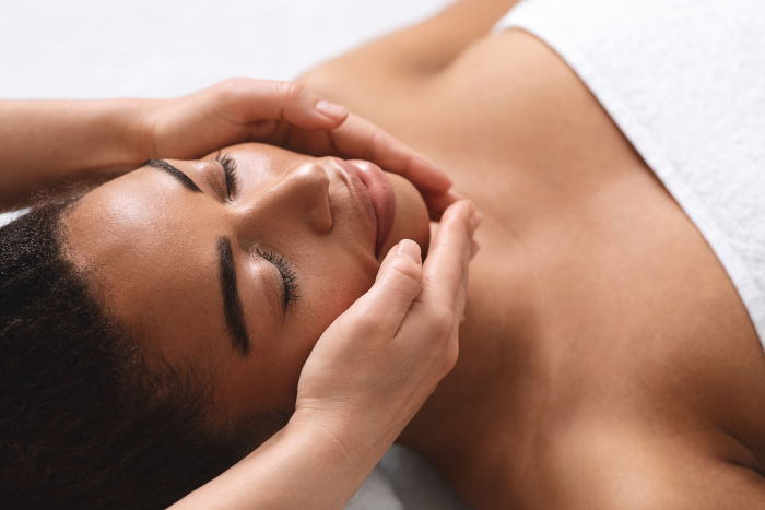 Closeup,Of,Therapist,Hands,Making,Facial,Massage,For,Young,Black